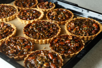 Not baked delicious cakes with nuts on pan.