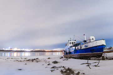 ships berth boat on shore in the winter night