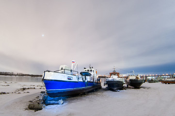 Fototapeta premium ships berth boat on shore in the winter night