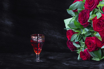 glass of wine and a bouquet of roses on a black background, black fur, Women's Day on 8 March