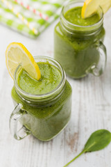 Vegetable and fruit cocktail, served in a jar, with fresh citrus and spinach.