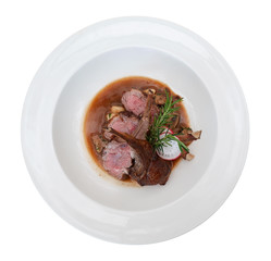Lamb steak in ceramic dish top view isolated on white background, clipping path included