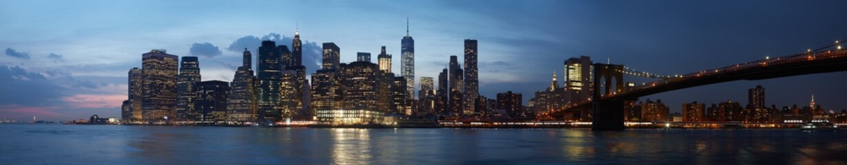 Fototapeta na wymiar New York city skyline panorama with Brooklyn bridge at sunset, natural colors