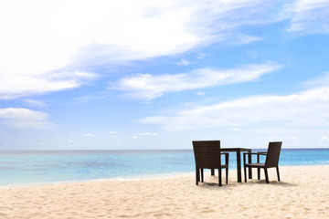 Fototapeta na wymiar Chair on the Beach Under Sunny Sky