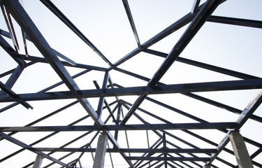 Metal roof structure with blue sky in background