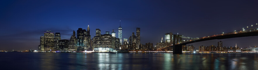 New York city panorama skyline with Brooklyn Bridge at night