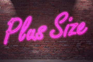 Obraz premium Leuchtreklame Plus Size an Ziegelsteinmauer