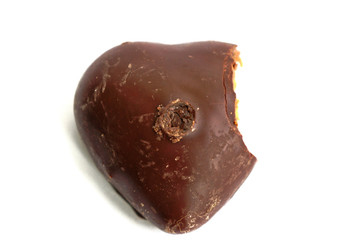 Chocolate covered gingerbread heart with a bite taken out of it