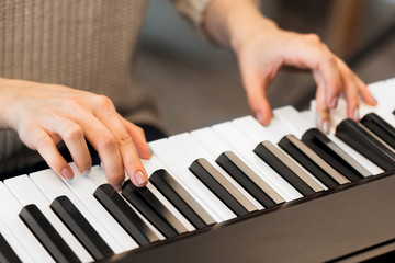 Obraz premium Closeup of hands playing piano. Music and hobby concept