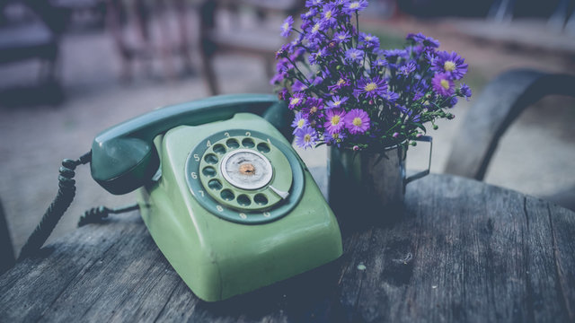 Vintage Pastel Green Rotary Telephone On Grunge Wooden Desk.