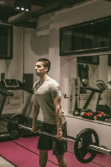 Obraz na płótnie Canvas Strong man working out at gym fitness club