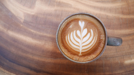 Top view of hot coffee latte art on wood table background