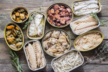 Assortment of cans of canned with different types of fish and seafood