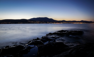 View from Tranmere on the River Derwent with illuminated Hobart, Tasmania with Mount Wellington in background
