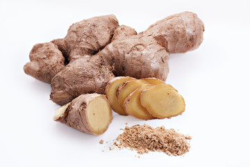 Ginger root with sliced pieces and powder on the white background