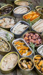 Assortment of cans of canned with different types of fish and seafood