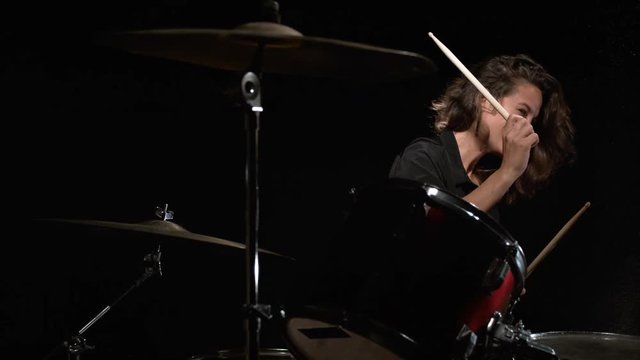 Camera follows female rock drummer performing. Shot with high speed camera, phantom flex 4K. Slow Motion. 