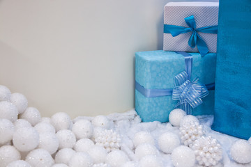Fototapeta na wymiar Christmas gifts with Christmas balls on a gray background