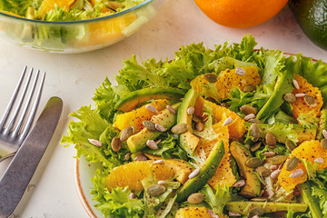Avocado orange salad with  pumpkin  and sunflower seeds.