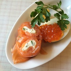 Close-up healthy smoked salmon and Salmon roe on boiled egg before starting main dish, cold appetizer