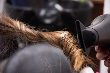 Professional hairdresser drying hair