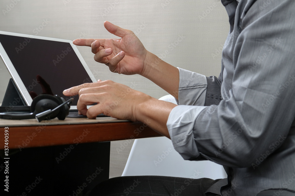 Poster business man using voip headset with digital tablet computer docking smart keyboard, concept communi