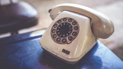 Retro rotary dial numbers telephone in vintage style picture.