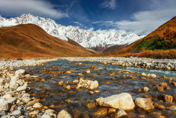 Snowy mountains and noisy mountain river. Georgia, Svaneti