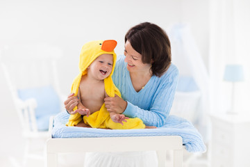 Mother and baby in towel after bath