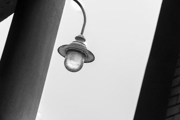 Creative look to the outdoor lighting - lamp / between column and brick wall in Vilnius city