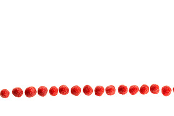 Ripe raspberries lying in a line isolated in white