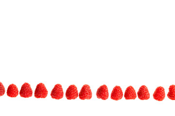 Ripe raspberries lying in a line isolated in white