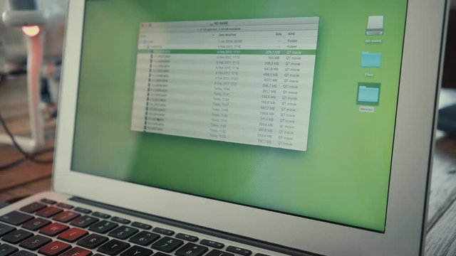 Close up view on portable laptop screen, copy footage files from connected drone into movies folder