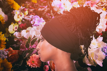 Pretty girl profile portrait with braided hairdo and colorful flowers