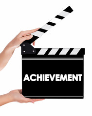 Obraz premium Hands holding a clapper board with Archievement text