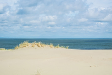 Fototapeta na wymiar The sand shore and the sea under the clouds at Lithuania, Curonian Spit, Nida dune.