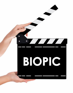 Hands holding a clapper board with BIOPIC text