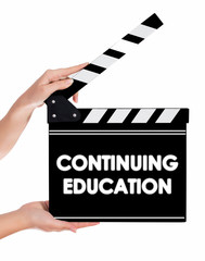 Obraz premium Hands holding a clapper board with CONTINUING EDUCATION text