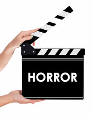 Hands holding a clapper board with HORROR text