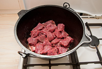 Raw meat in a cast iron pot
