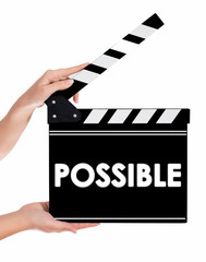 Obraz premium Hands holding a clapper board with POSSIBLE text