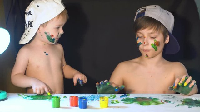 Happy kids playing with finger paints