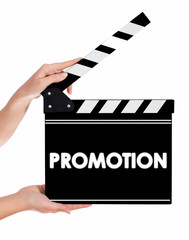 Obraz premium Hands holding a clapper board with PROMOTION text