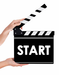 Hands holding a clapper board with START text