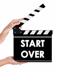 Obraz premium Hands holding a clapper board with START OVER text