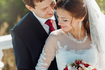 the bride and groom on the background of urban architecture