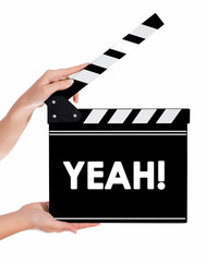 Obraz premium Hands holding a clapper board with YEAH text
