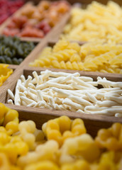 Variety of types, colors and shapes of Italian pasta. Dry pasta background