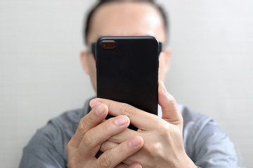 Designer hand using mobile payments online shopping,omni channel,customer network connection,wooden desk,icons graphic interface screen,eyeglass