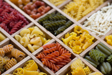 Variety of types, colors and shapes of Italian pasta. Dry pasta background